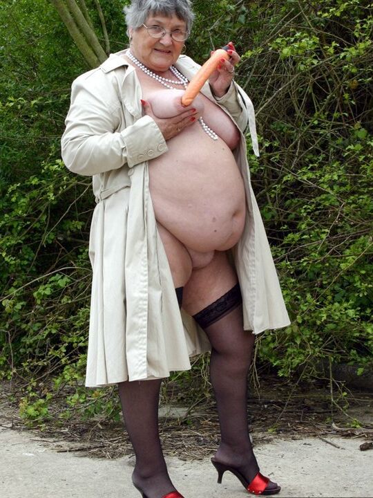 20P Fat nan Grandma Libby flashes by the trees in an overcoat before masturbating