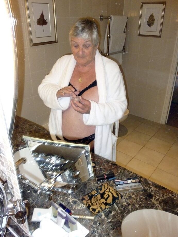20P Fat nan Grandma Libby removes a bathrobe to pose nude in a cupless bra