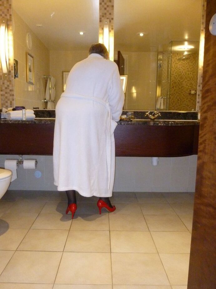 20P Fat nan Grandma Libby removes a bathrobe to pose nude in a cupless bra