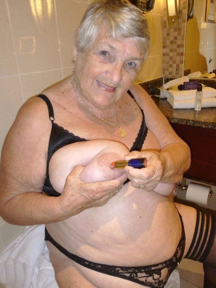 20P Fat nan Grandma Libby removes a bathrobe to pose nude in a cupless bra