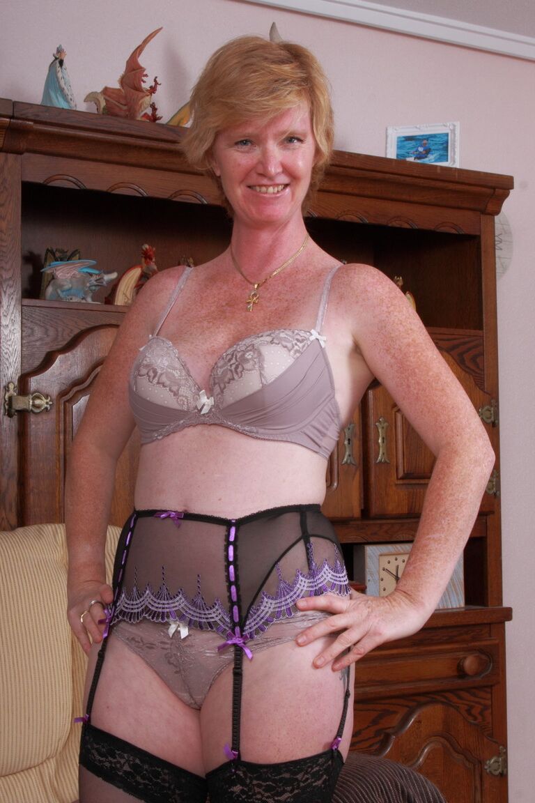 15P Horny granny laughingly displays the wet cameltoe under her sheer undies