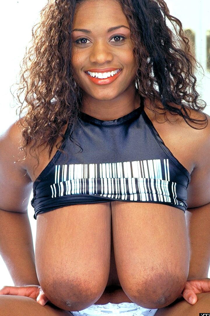 21P Sammie Black, une MILF aux cheveux bouclés, exhibe ses seins excessivement gros.