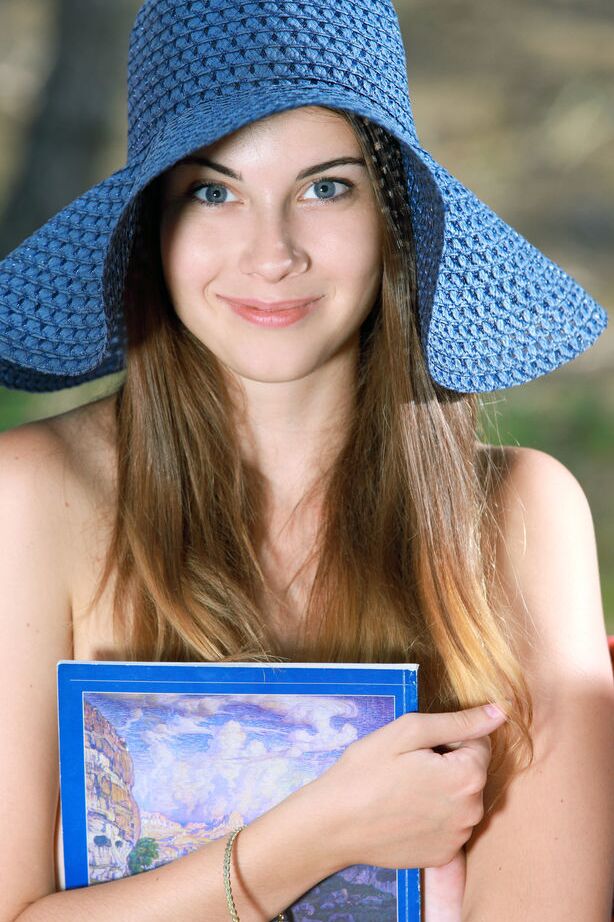 18P Naked beauty Marta E poses with her big tits bare on a hammock in the woods