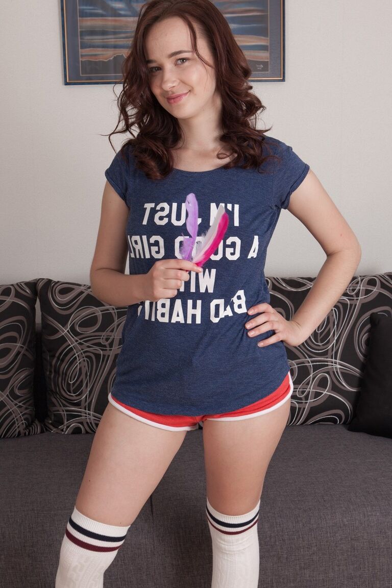 17P Brunette cutie with hairy crotch Julia Moore strips and plays with feathers
