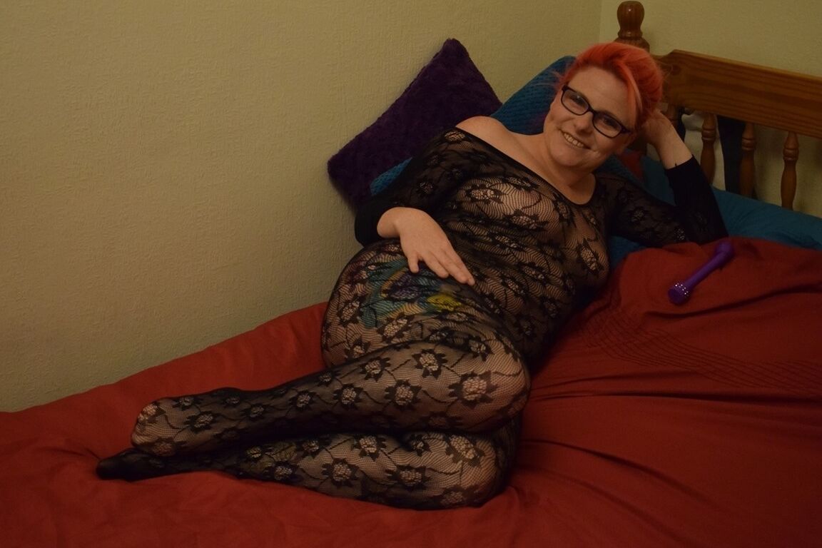 20P Redhead amateur Mollie Foxxx masturbates on a bed in a crotchless bodystocking