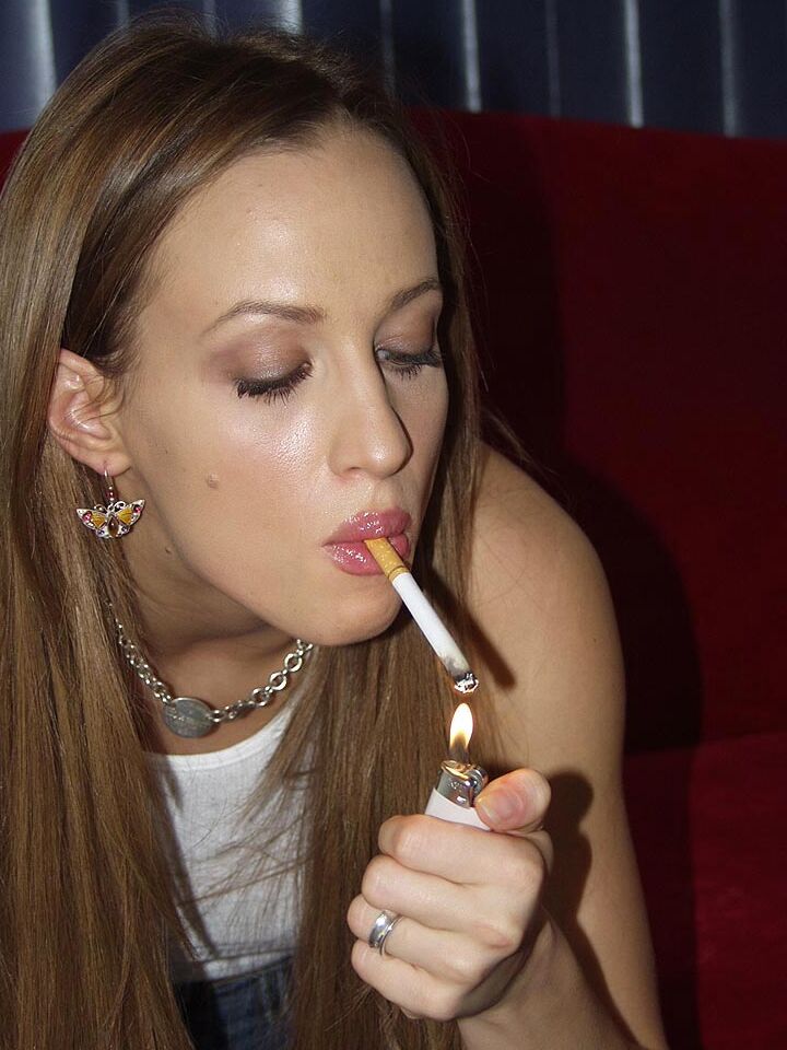 16P Amateur model Bunny Luv puffs on a smoke before getting totally naked on couch