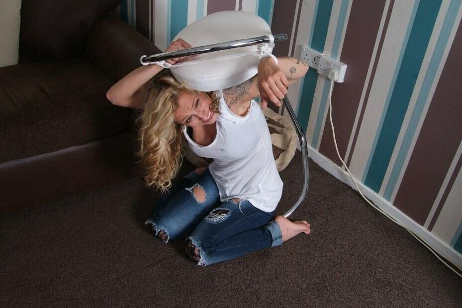 16P Fully clothed blonde Katie C struggles while restrained with rope bindings