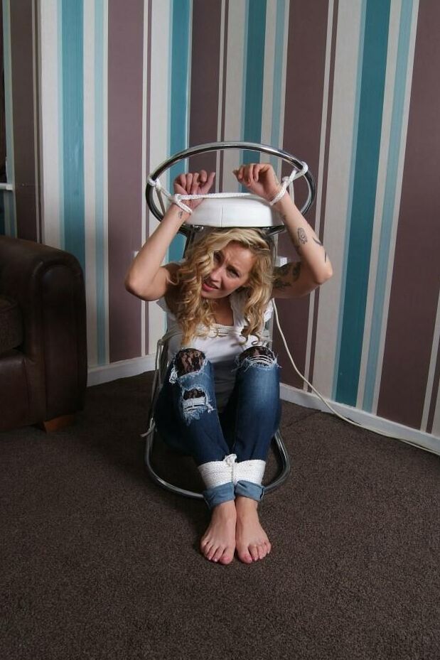 16P Fully clothed blonde Katie C struggles while restrained with rope bindings
