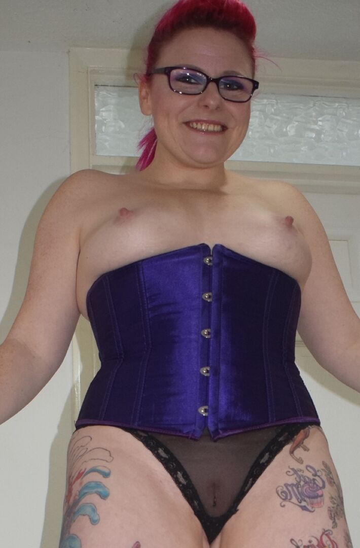 16P Tattooed chick Mollie Foxxx goes topless in a satin waist cincher and glasses