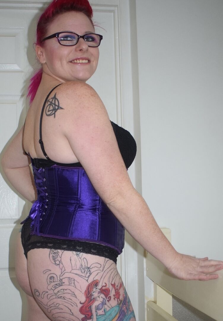 16P Tattooed chick Mollie Foxxx goes topless in a satin waist cincher and glasses