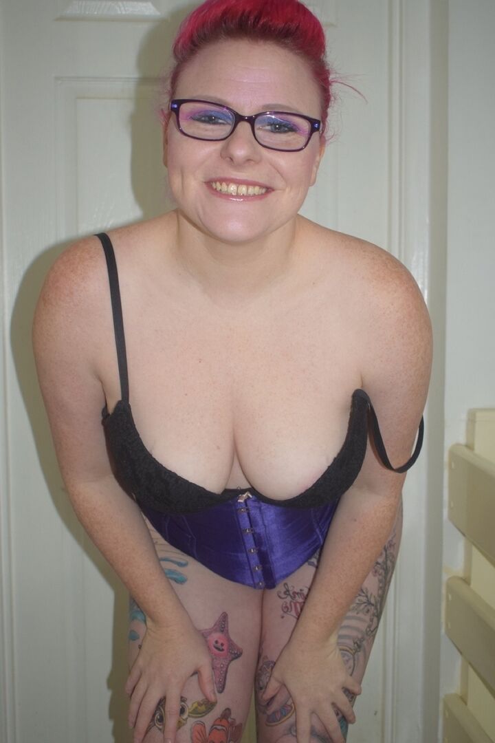 16P Tattooed chick Mollie Foxxx goes topless in a satin waist cincher and glasses