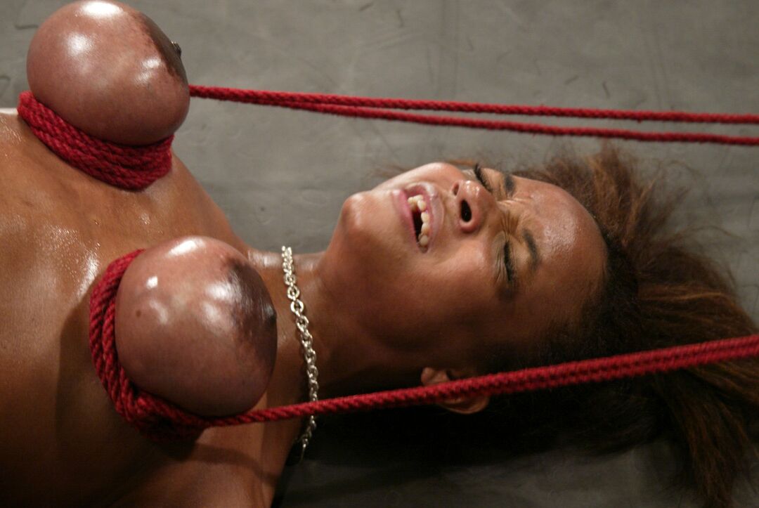 21P Ebony with big boobs Sinnamon Love enjoys a bondage session in a basement