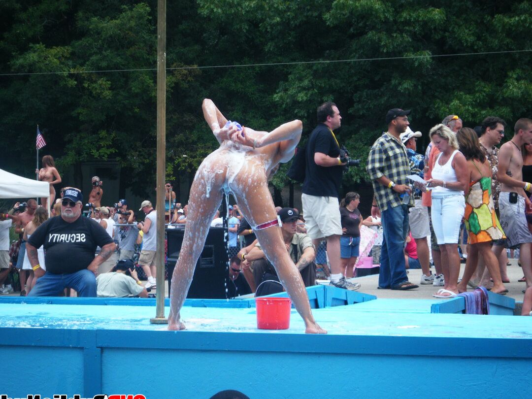 12P Lots of big tit girls stripping on an outdoor stage for all to watch