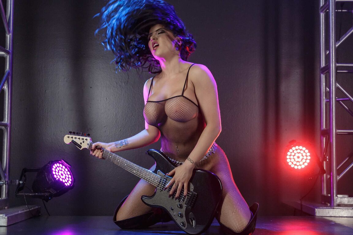 21P Busty MILF rock star Romi Rain strips on the stage & plays in fishnets & boots