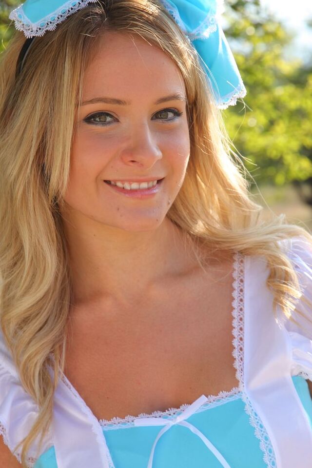 16P Cute blonde Elle Richie removes her cute outfit to pose topless in a field