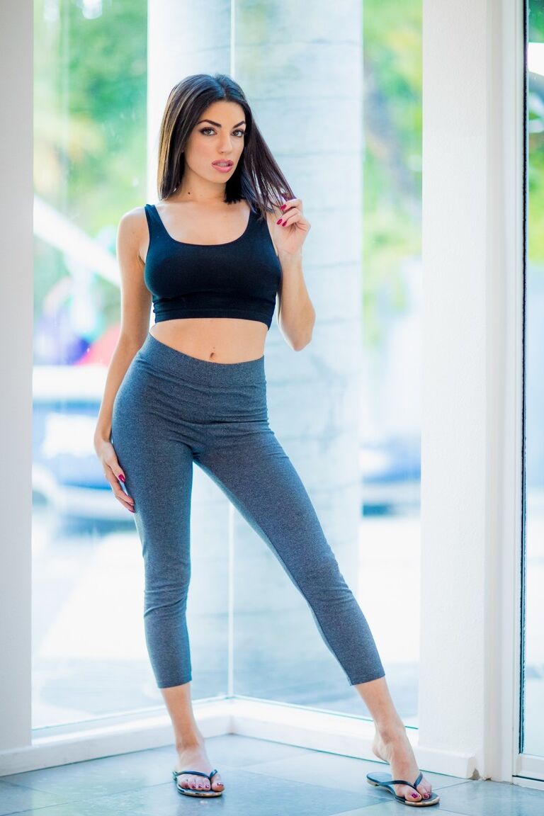 15P Gorgeous brunette Darcie Dolce uncovers great tits before removing tight pants