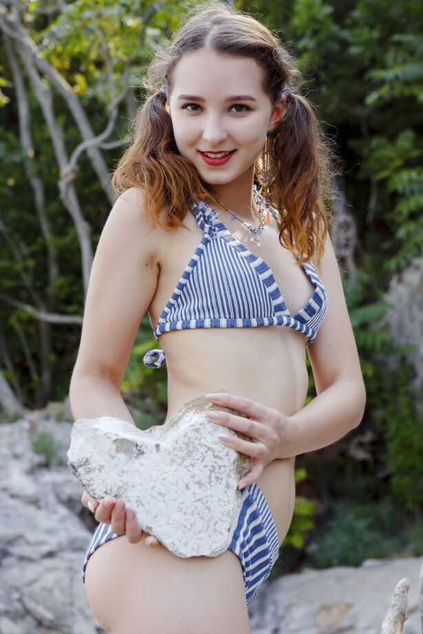 18P Sweet teen Ava sports red lips while doffing a bikini to go naked by the water