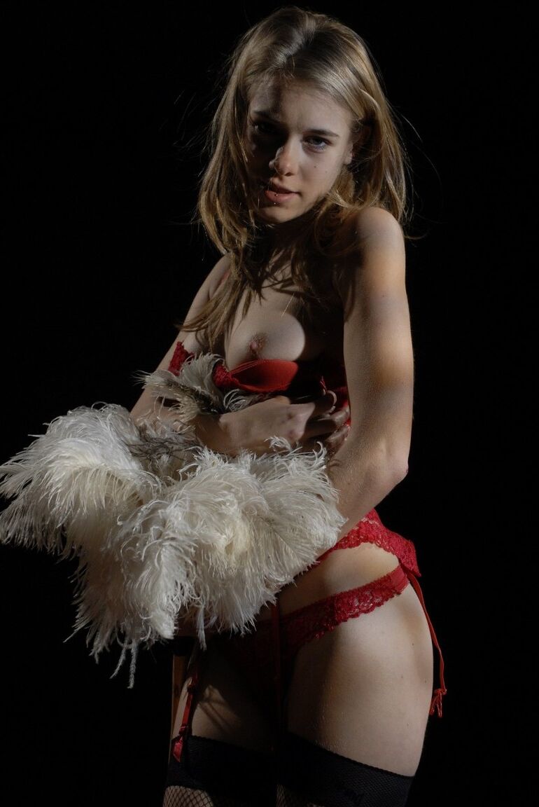 15P Glamour model Kelly holds a feather duster while removing hot lingerie