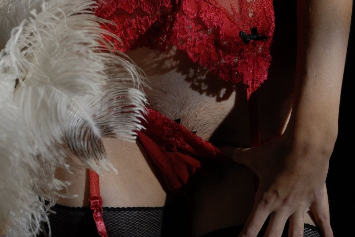 15P Glamour model Kelly holds a feather duster while removing hot lingerie