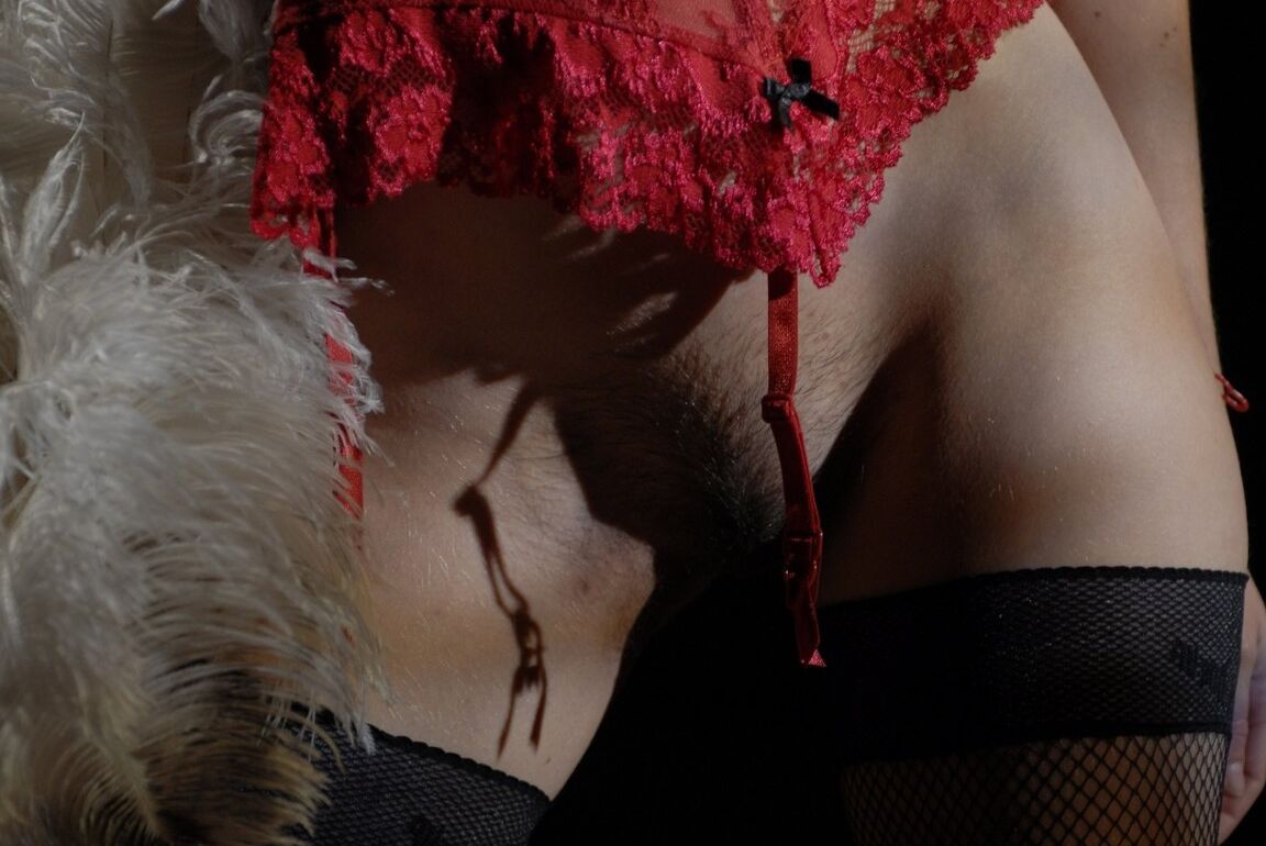 15P Glamour model Kelly holds a feather duster while removing hot lingerie