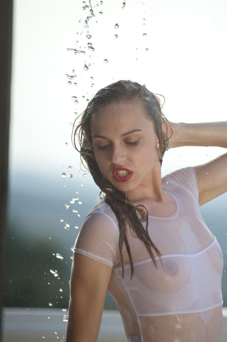 12P Thin teen in see thru swimsuit gets caught in a torrential downpour on balcony
