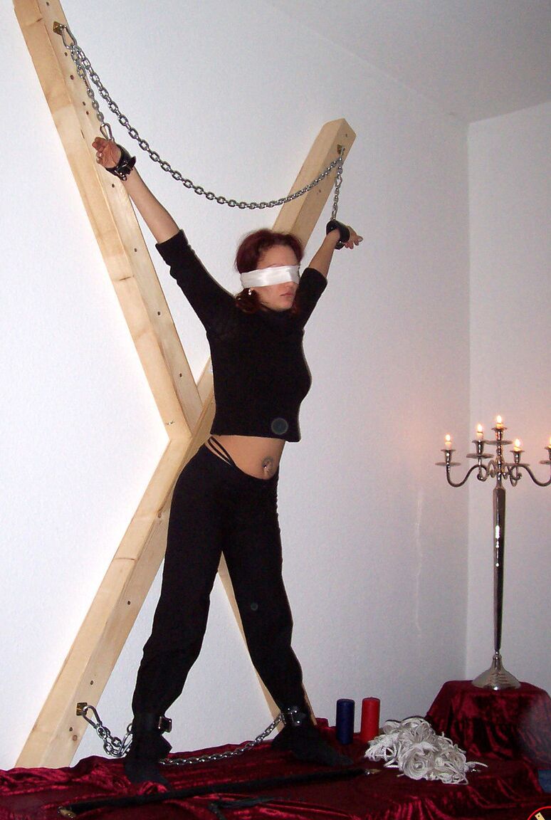 16P Blindfolded redhead Lilu Natilova is chained to a St Andrew's Cross