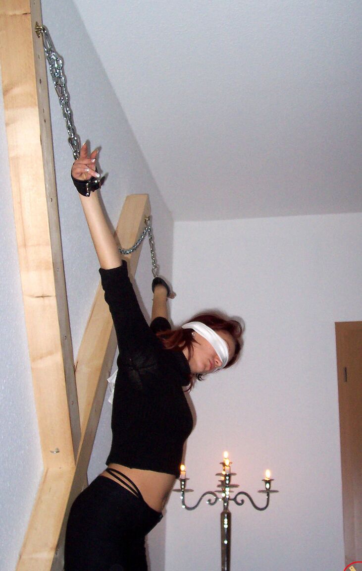 16P Blindfolded redhead Lilu Natilova is chained to a St Andrew's Cross