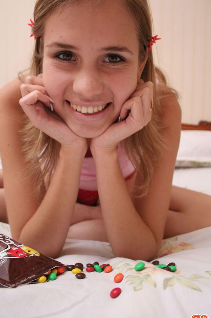 20P Young looking first timer adorns her totally naked body in M&M'S