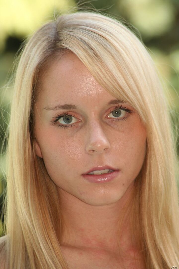 16P Naked blonde Kara stands with hands on hips in solo action by the pool