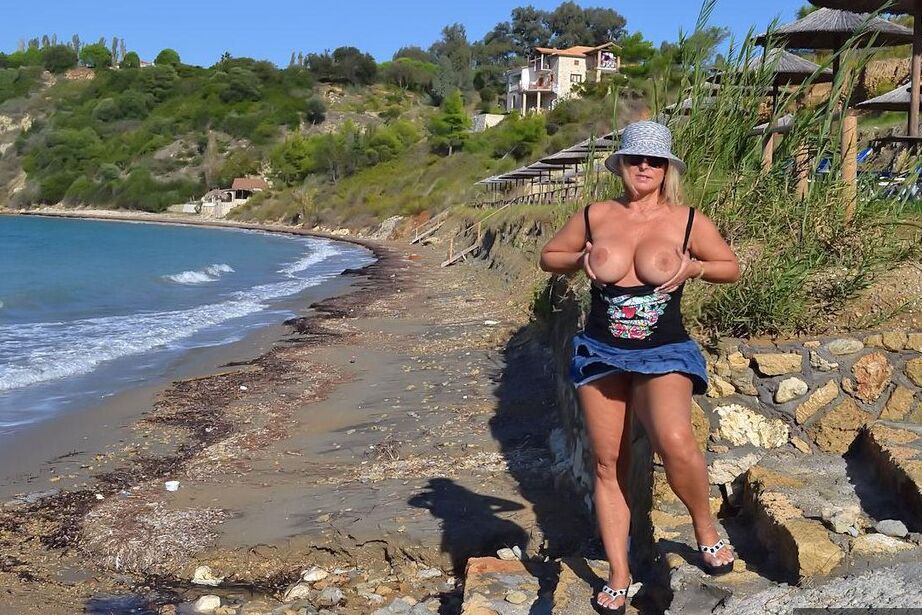 19P Hugely busty mature slut Chrissy swims and lounges at the beach stark naked