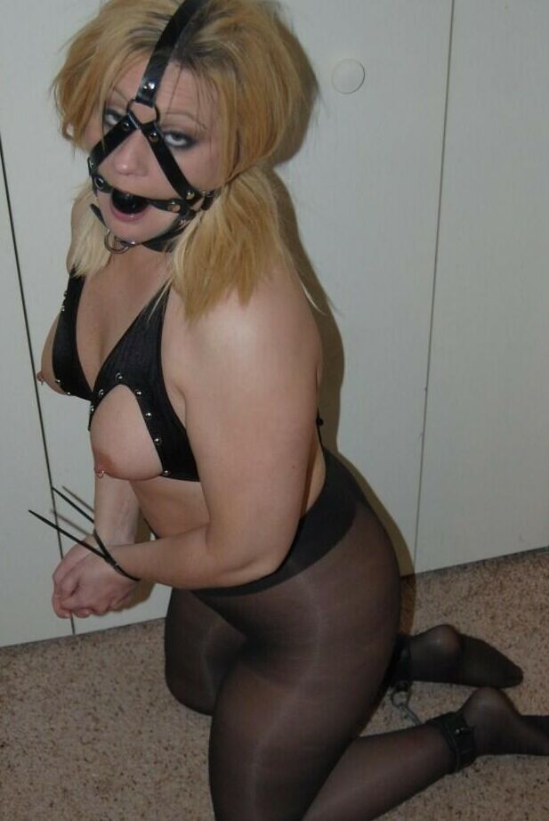 16P Blonde BBW displays her exposed breasts while ball gagged and restrained