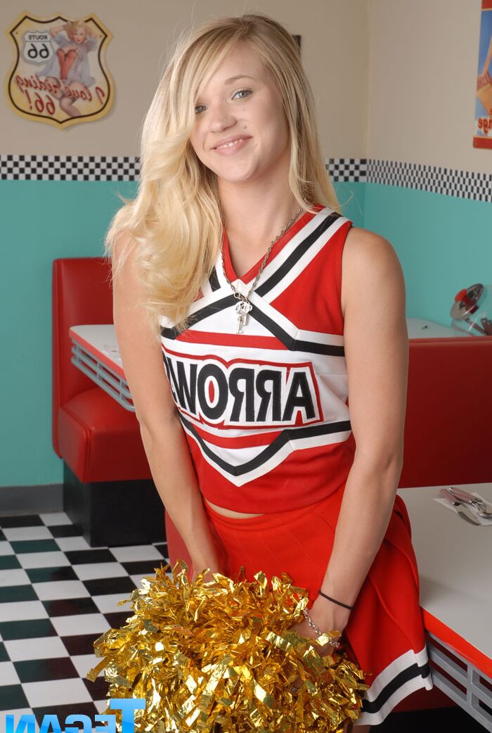 20P Cute college blonde Tegan Summers poses in a cheerleader outfit at a diner