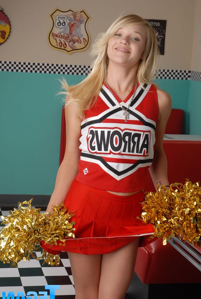 20P Cute college blonde Tegan Summers poses in a cheerleader outfit at a diner