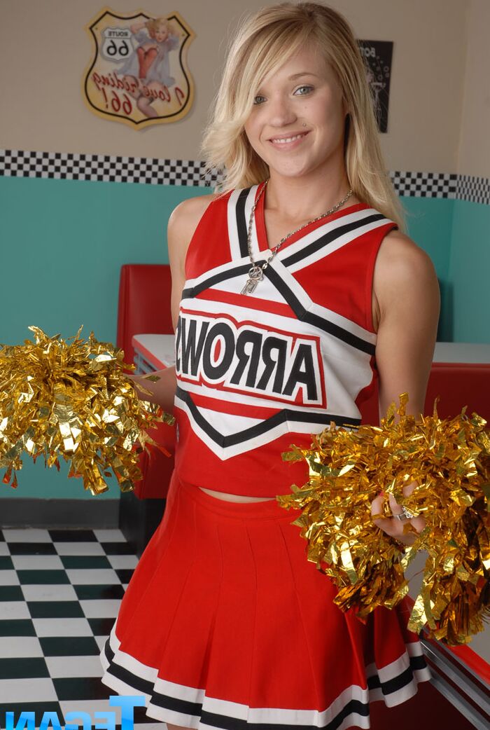 20P Cute college blonde Tegan Summers poses in a cheerleader outfit at a diner