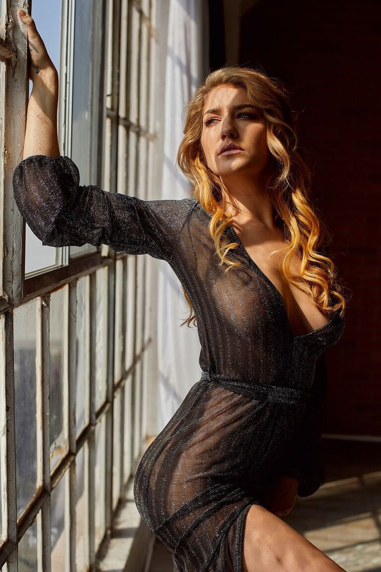 12P Beautiful girl Skye Blue strikes great nude poses in front of a window