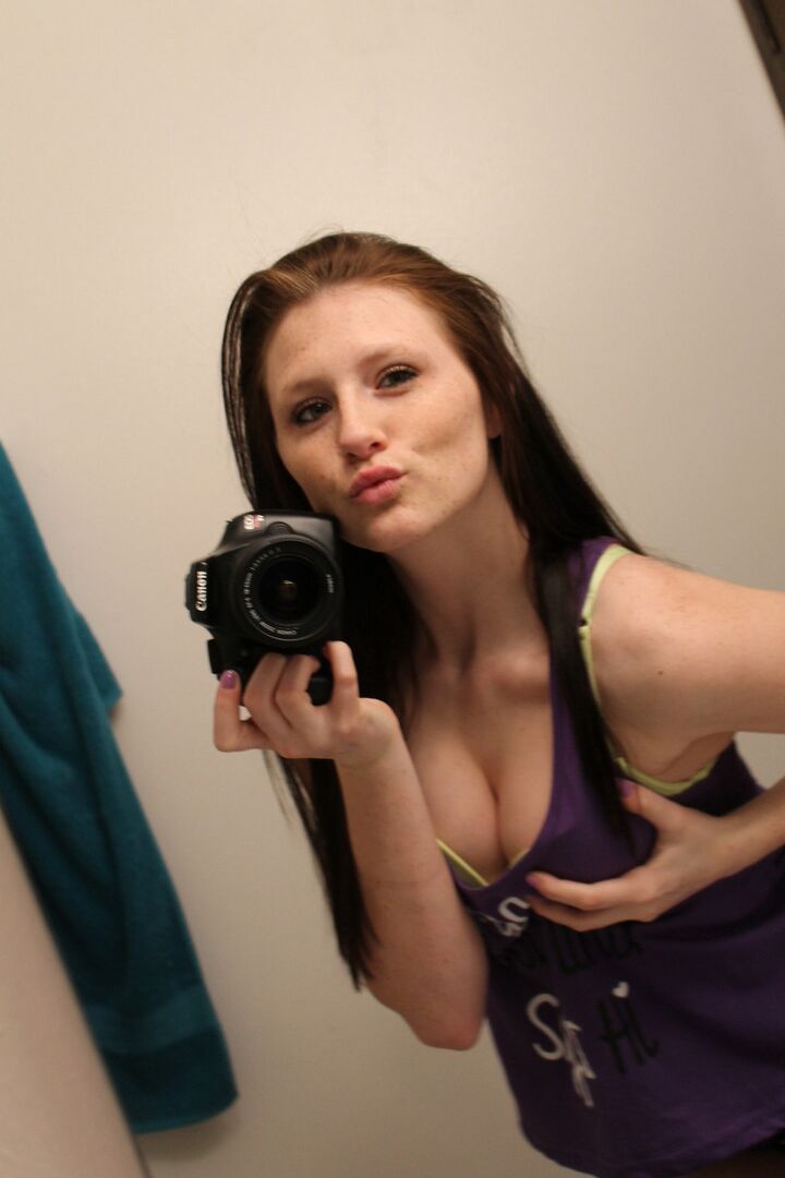 12P Amateur chick Freckles 18 sticks out her tongue while taking mirror selfies