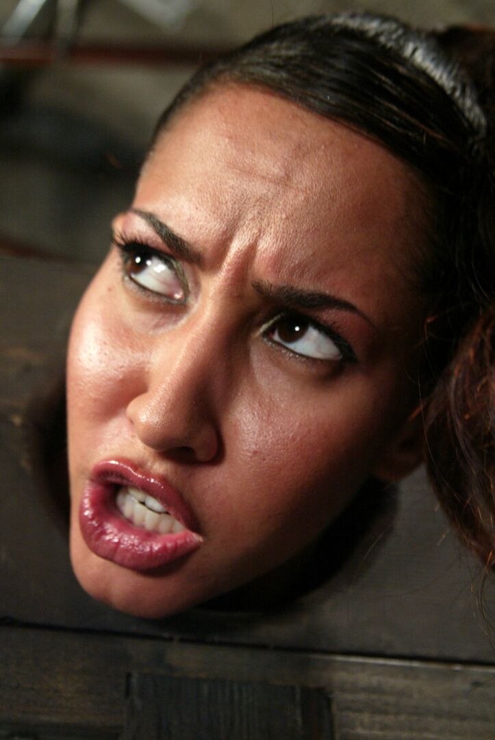 17P Isis Love finds herself being humiliated in the stocks with a hook in her anus