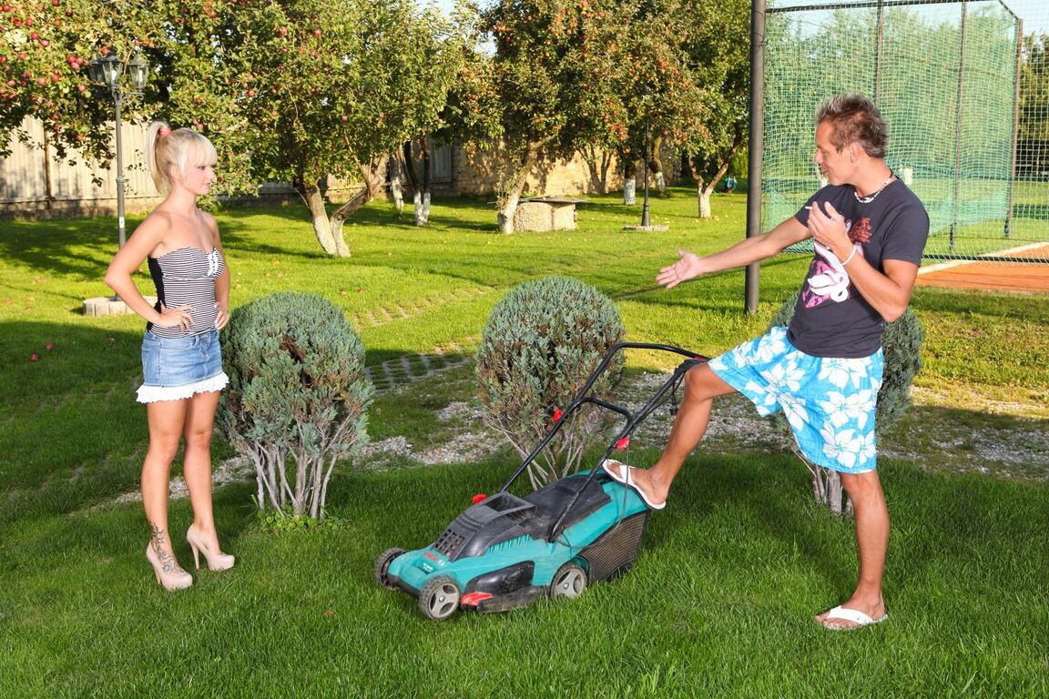 15P Blonde woman changes into red latex boots before dominating a man on a lawn