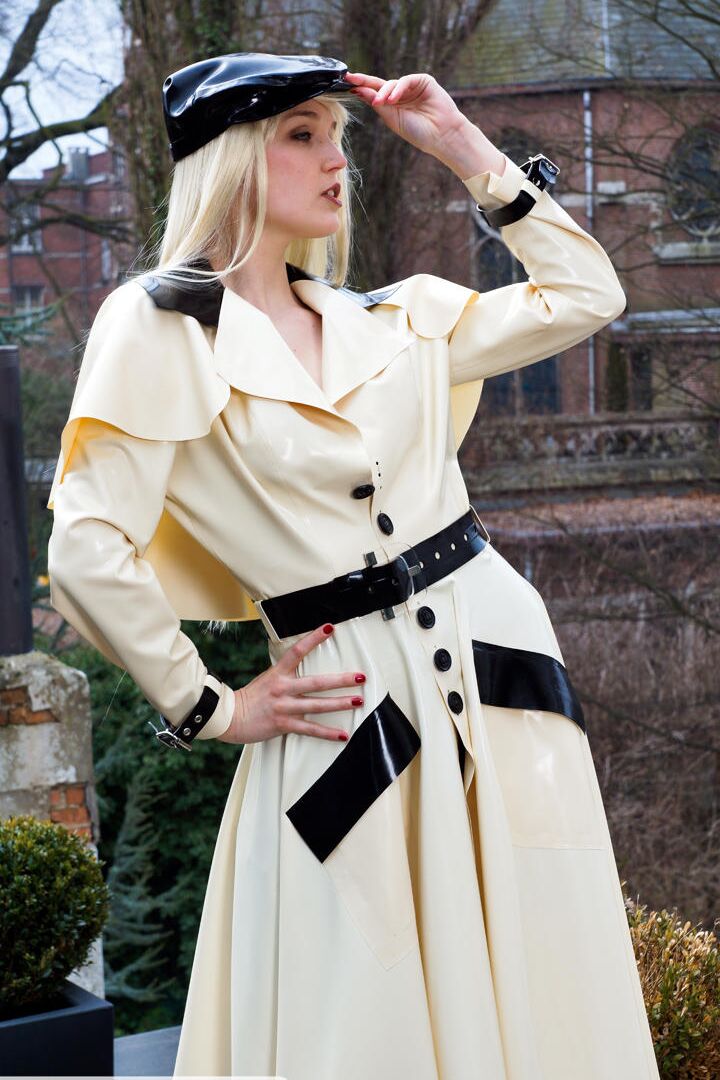 16P Classy blonde flashes the village below on her patio in latex attire