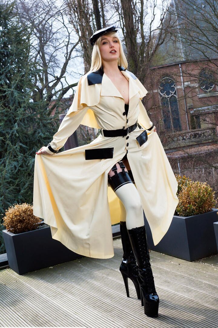 16P Classy blonde flashes the village below on her patio in latex attire