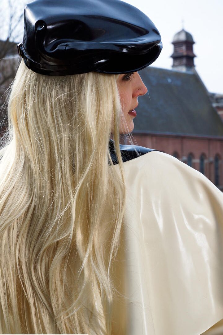 16P Classy blonde flashes the village below on her patio in latex attire