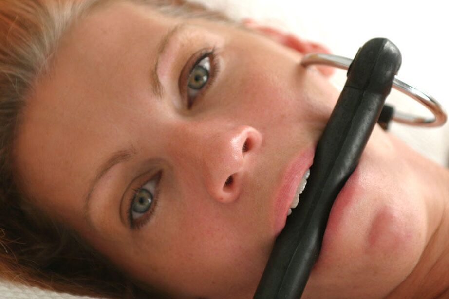 12P Naked amateur model is tied to a bed with a horse bit in her mouth