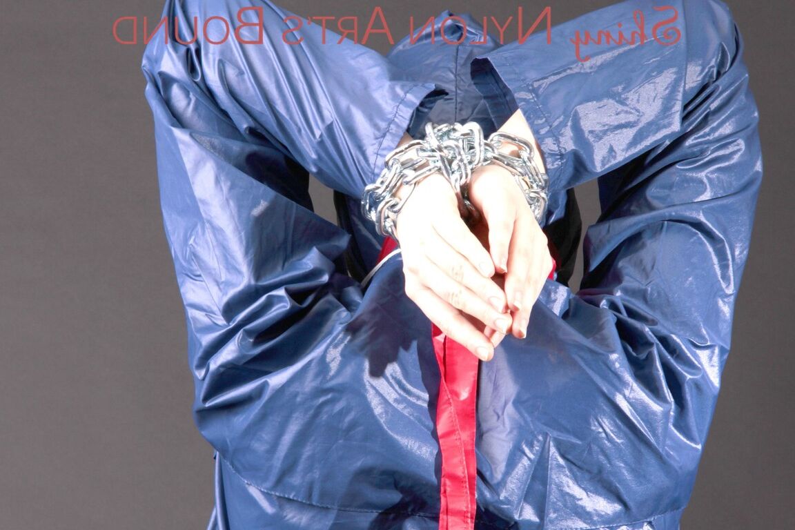 16P Mara wearing a rain skirt and a rain coat with rubber boots being tied and