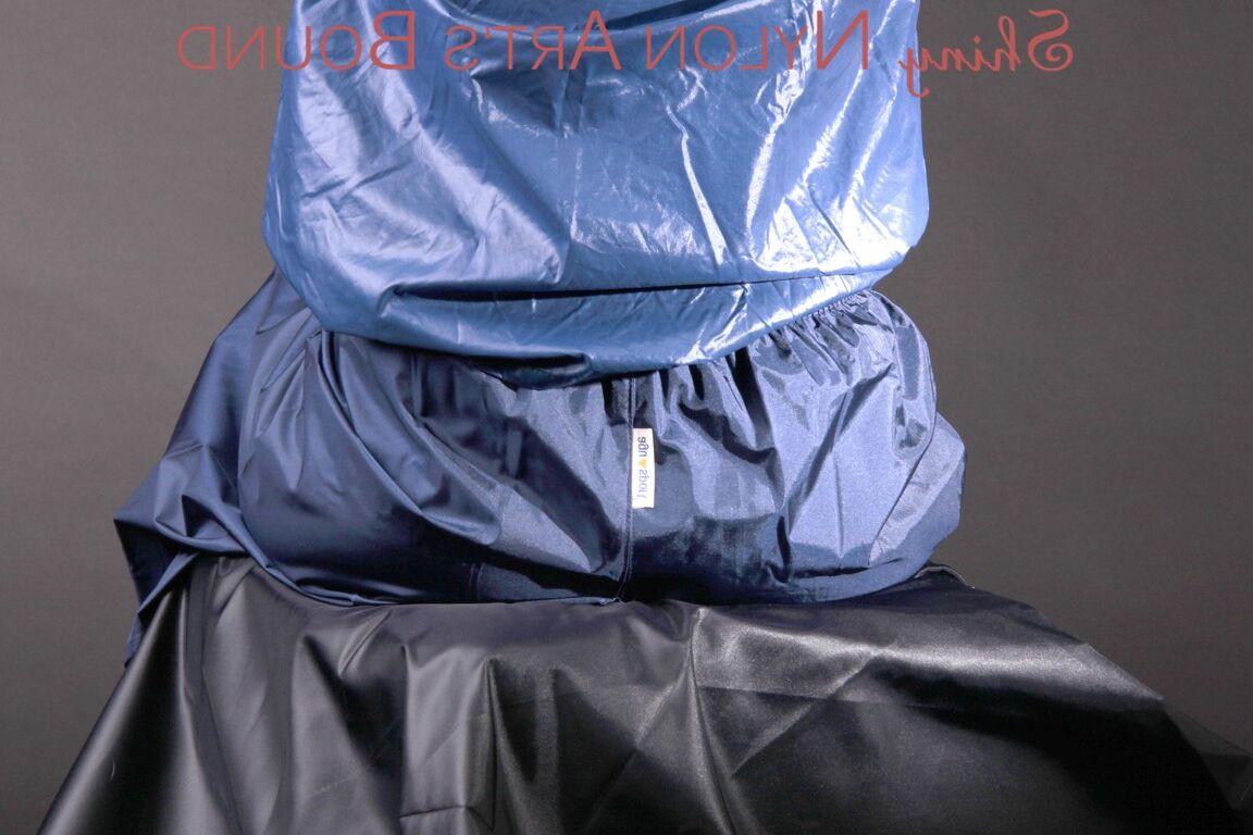 16P Mara wearing a rain skirt and a rain coat with rubber boots being tied and