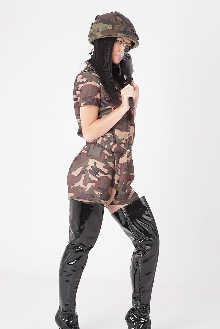 15P Sexy brunette releases her tits from a camouflage dress while wielding a rifle