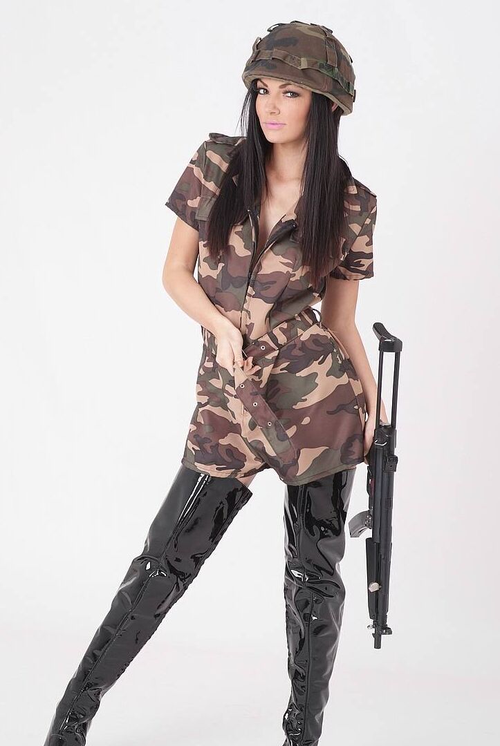 15P Sexy brunette releases her tits from a camouflage dress while wielding a rifle