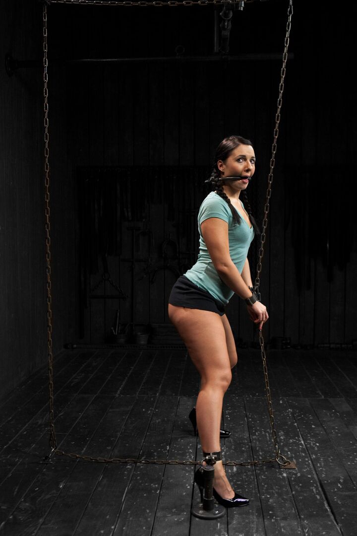 21P Raven-haired babe Ashli Orion gets whipped while tied up in the dungeon