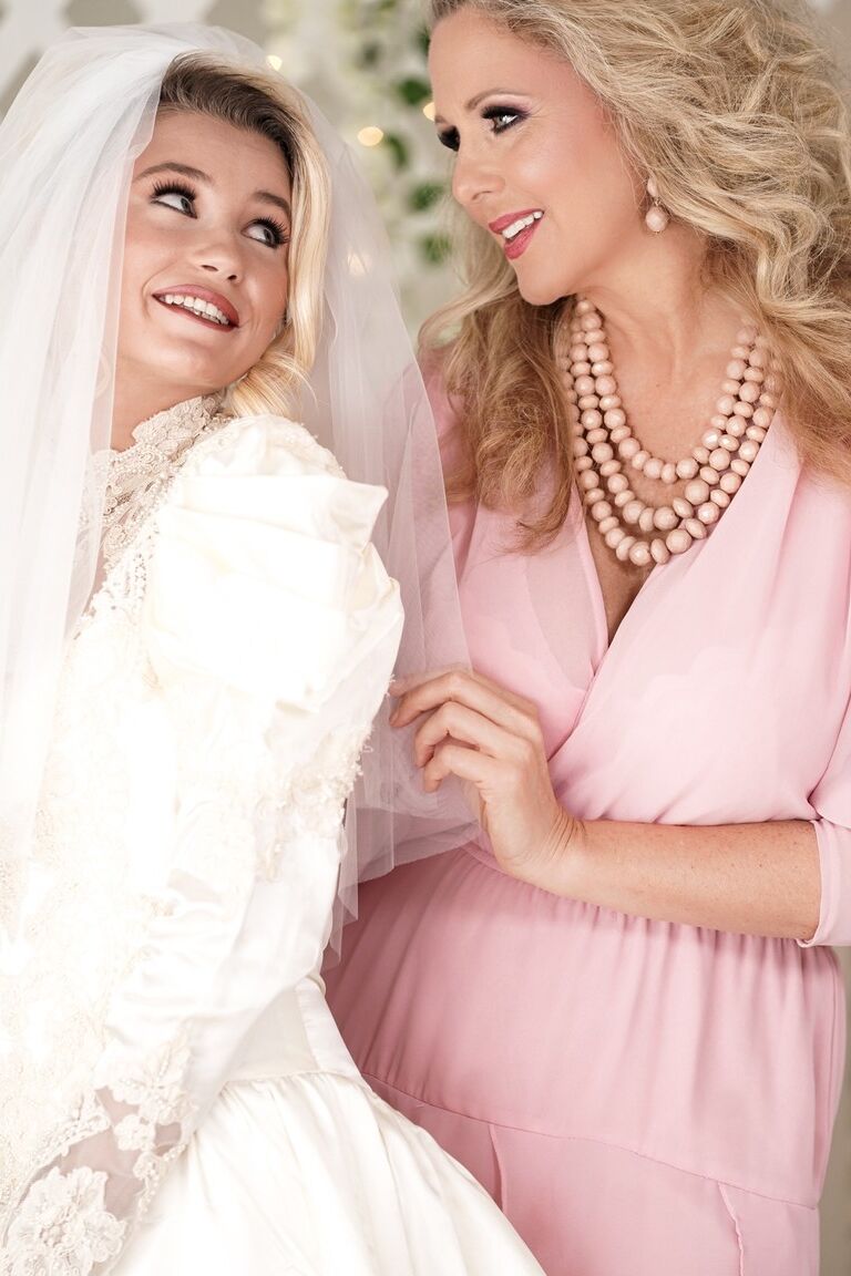 15P Carolina Sweets is affixed with a garter before a lesbian wedding to Julia Ann