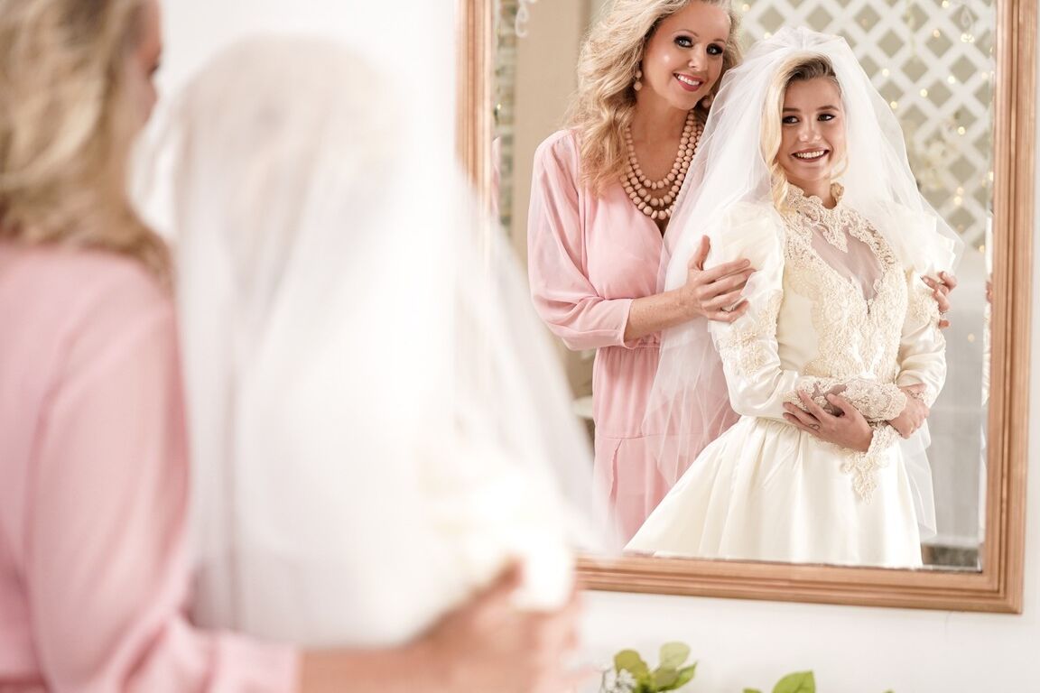 15P Carolina Sweets is affixed with a garter before a lesbian wedding to Julia Ann