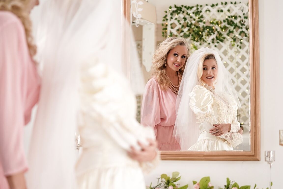 15P Carolina Sweets is affixed with a garter before a lesbian wedding to Julia Ann